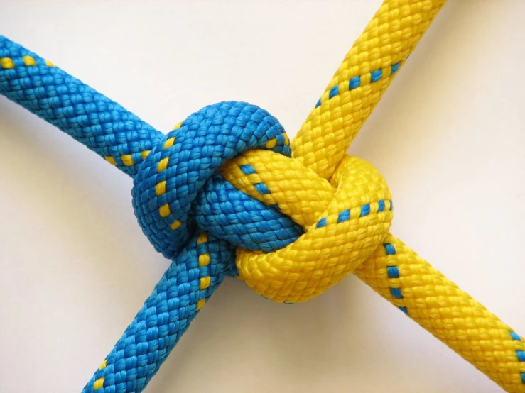 a close up of an untangled blue and yellow rope