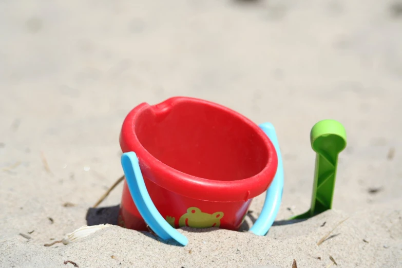 a toy beach chair and sandpit in the sand