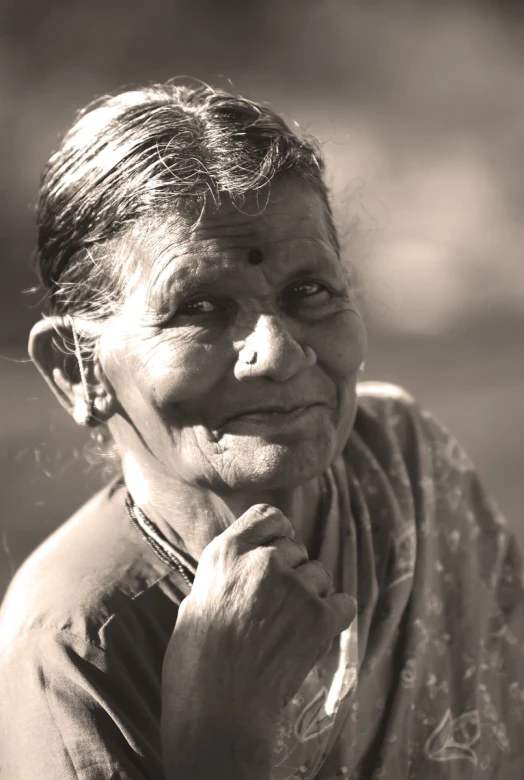 an older woman with long hair in front of a field