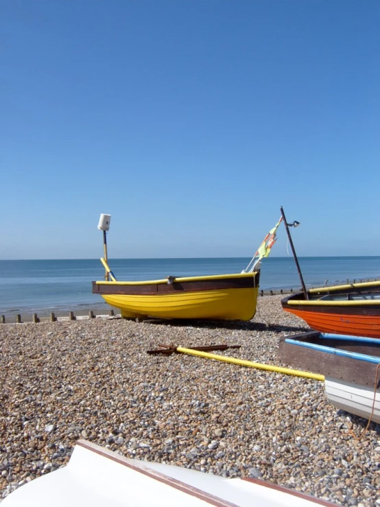 several boats sit on a shore line on a clear day