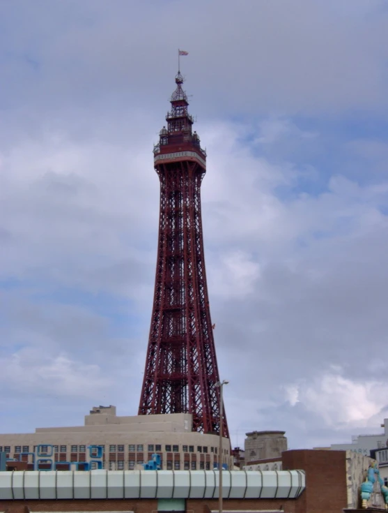 a tall tower with a red and white sign on top