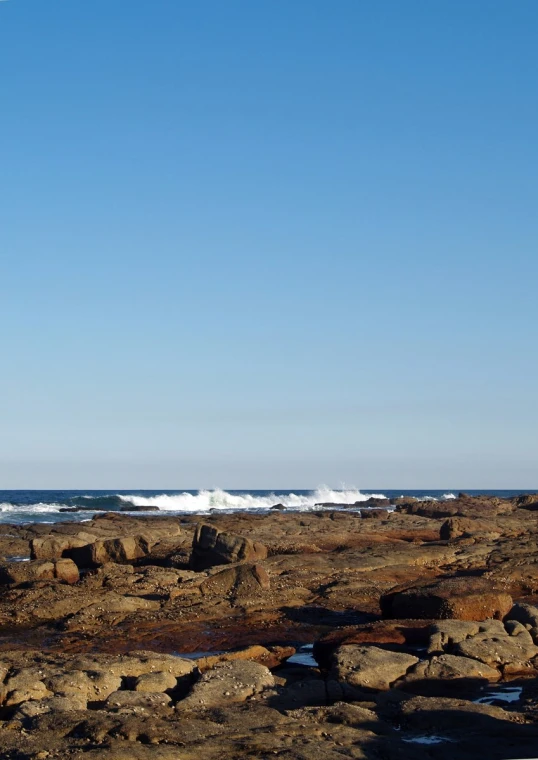 a person on a surfboard in a large area of rocks