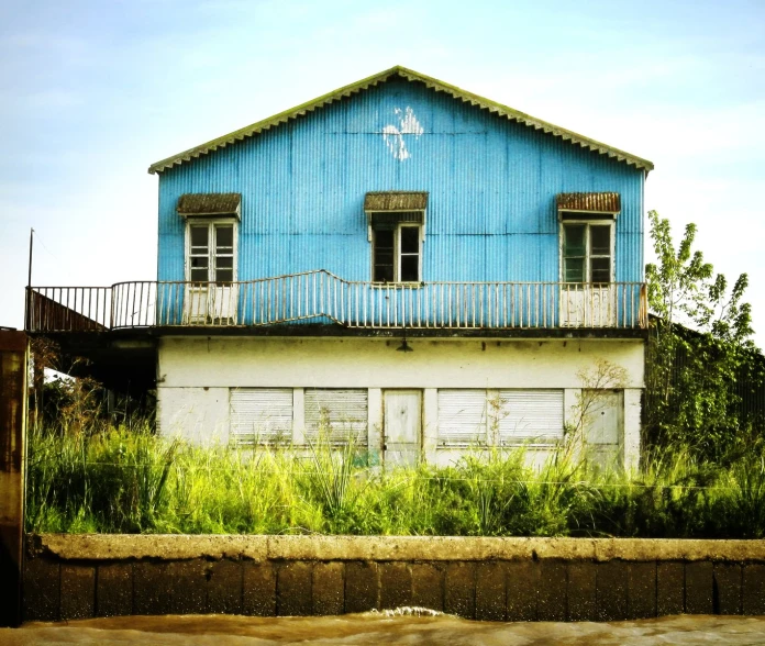 a building has a blue colored paint and balconies