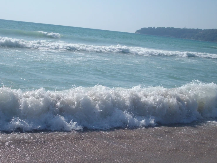 a wave in the sand at the ocean's edge