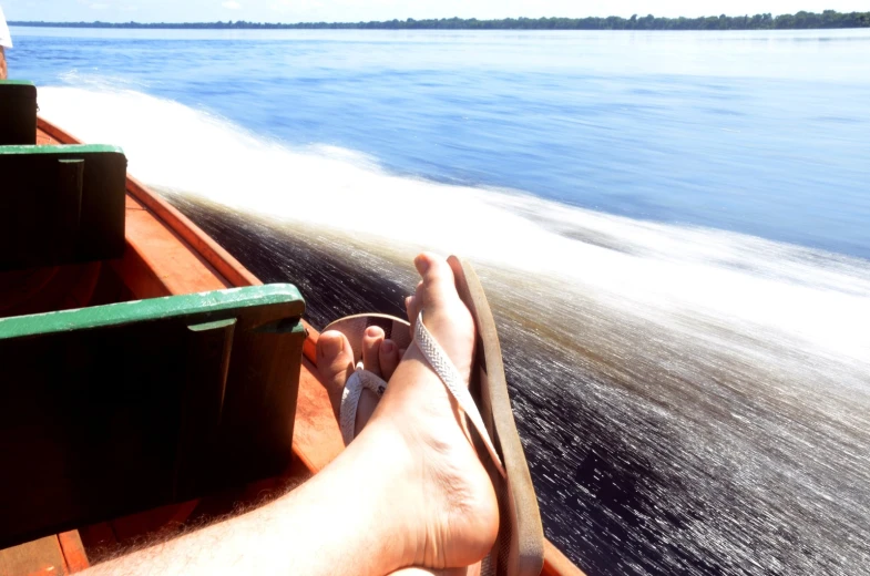 the view from the back of a boat as it makes its way down a river