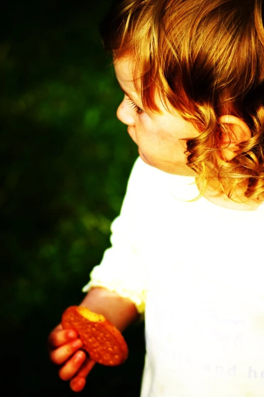 a close up of a child's hands holding soing