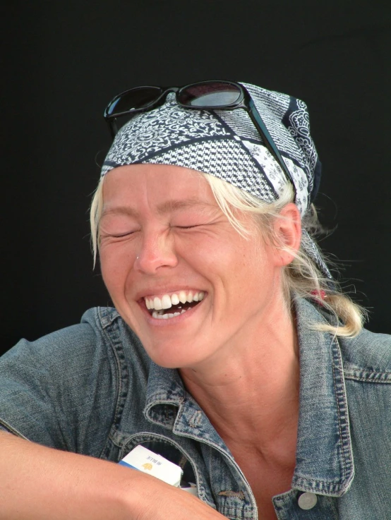 a woman with her eyes closed and wearing a denim jacket