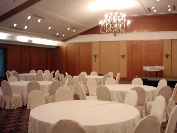 white chairs set up in a banquet room with chandelier