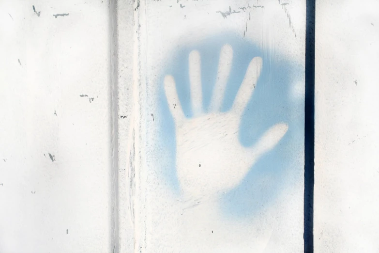 a hand is projected on a frosted window