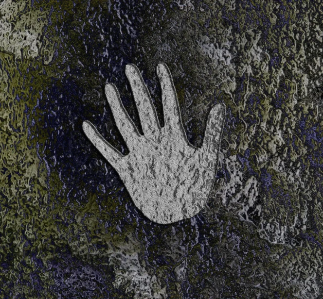 a hand reaching out to the ground in front of black and green foliage