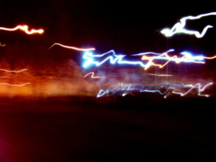 a blurry image of colorful lights in the dark