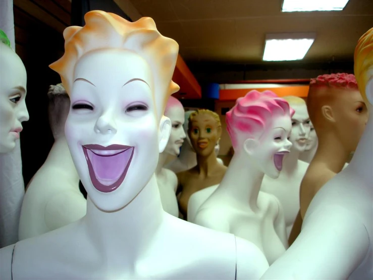 many mannequins in white and yellow with colored hair