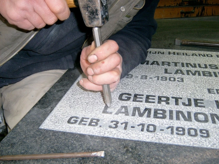 a man  some glass in a piece of concrete