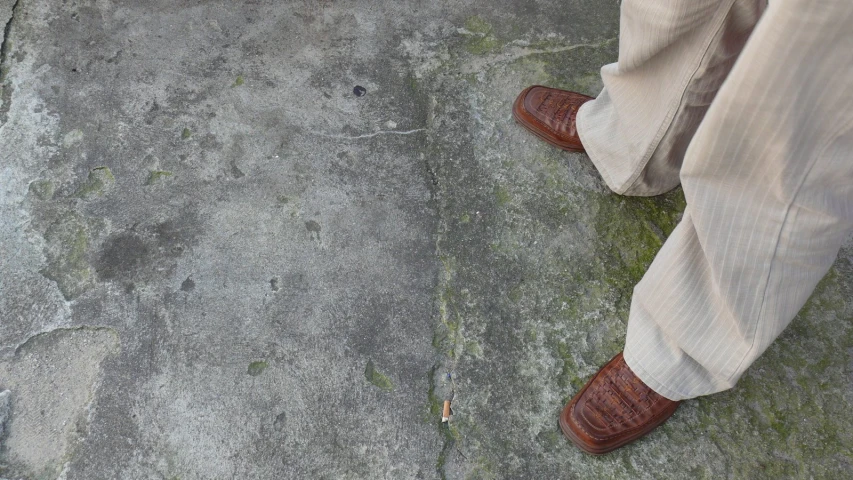 the man's shoes are wearing brown dress shoes