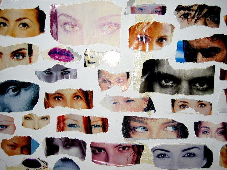 a close up of a cut out of paper with pictures of faces