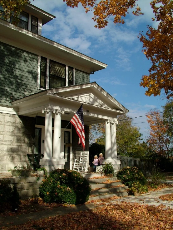 a large american flag on the front porch