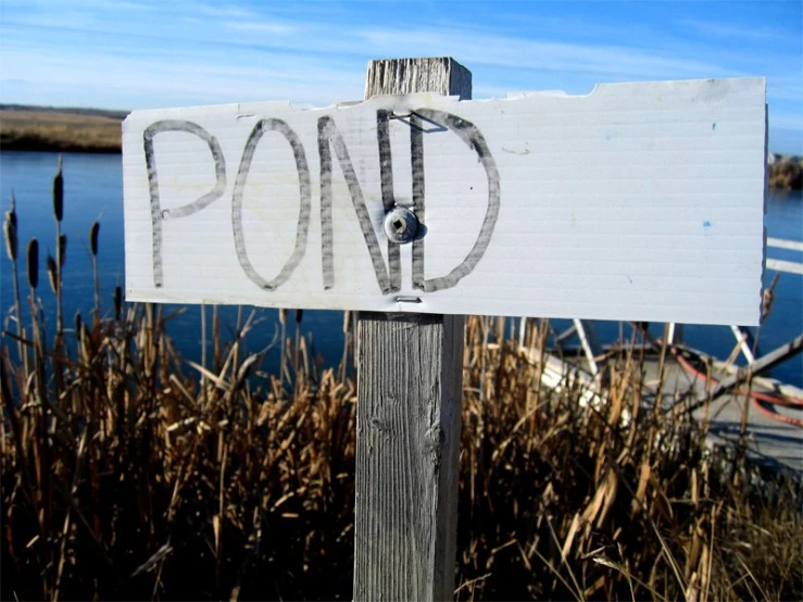 a wooden post that has a sign on it