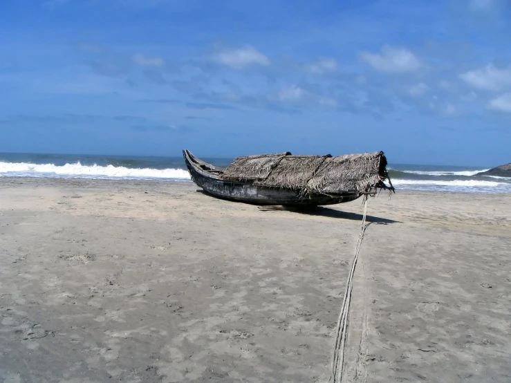 a boat that is sitting in the sand