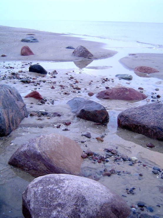 rocks are washed and covered in foamy water