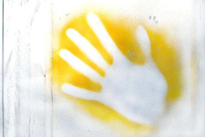 a hand with an yellow circle in the middle