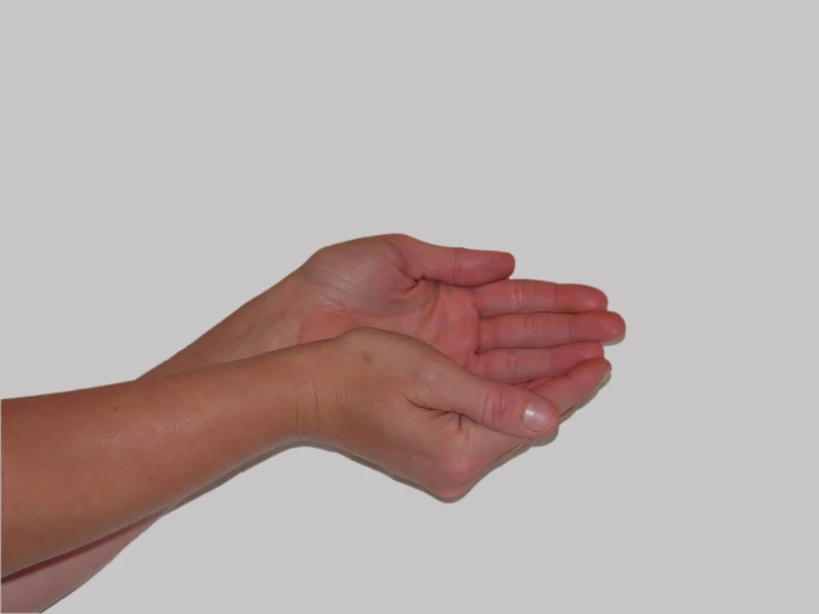 a person holding out their hand in the air