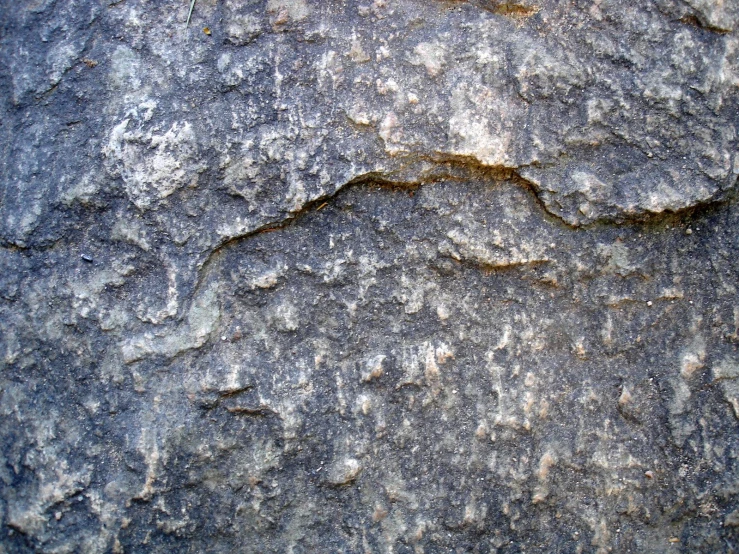 a textured wall with small s and little snow on it