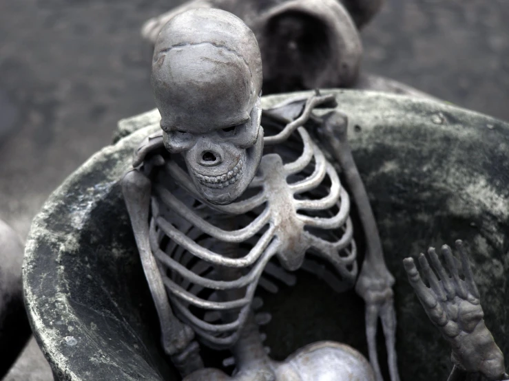 two skeleton sculptures sitting next to each other