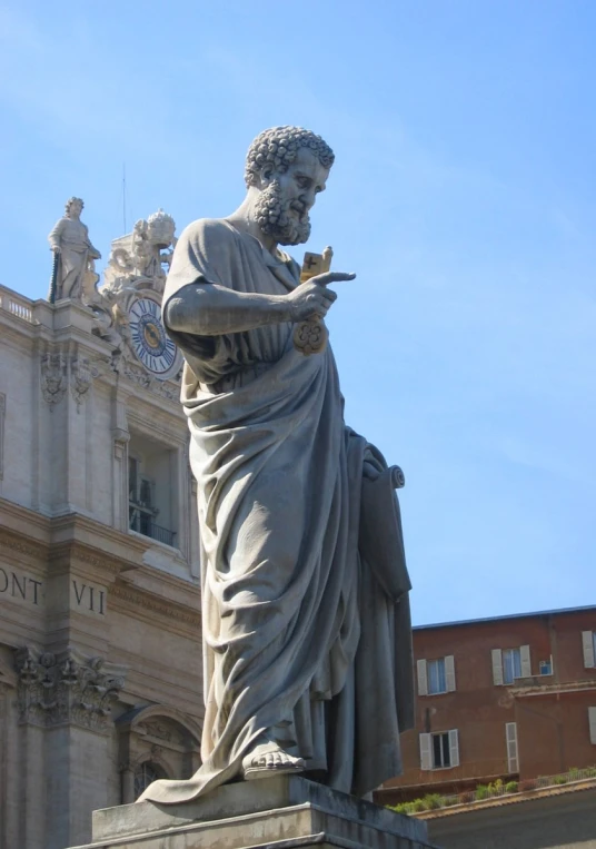 the statue stands with a sword in one hand and is wearing robes and holding a pocket watch