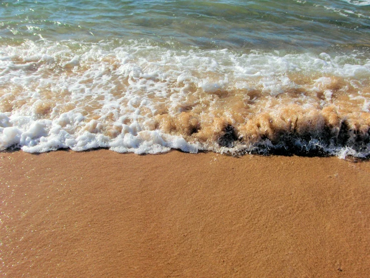 the water is brown and foamy at the beach