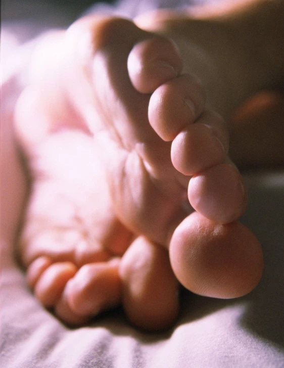 the feet and ankles of a baby that is born