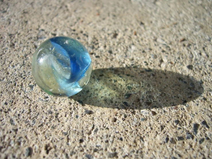 a closeup of a glass ball on a sidewalk