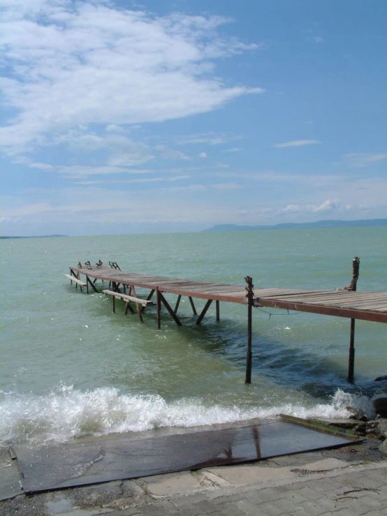 a pier extending into the ocean during a sunny day