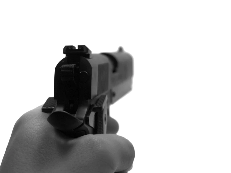 a gun being held in someones hand on white background