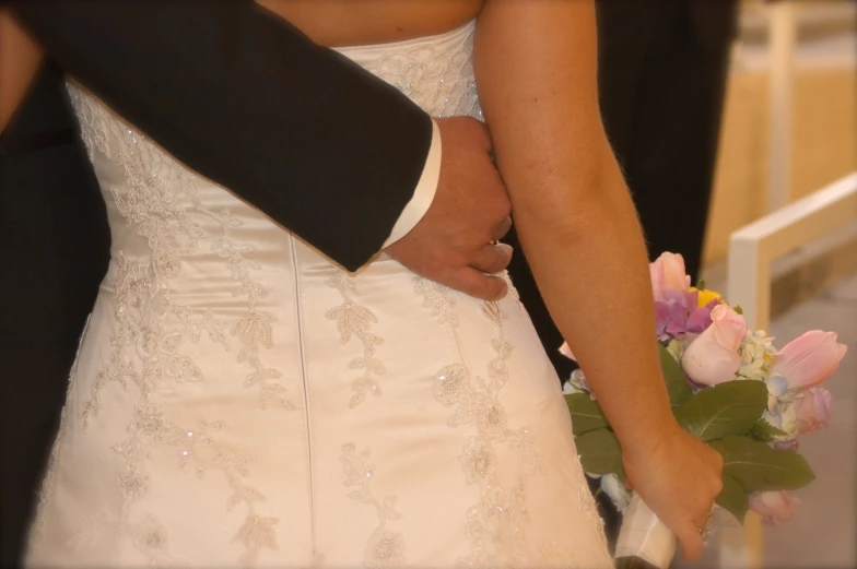 the bride and groom hold hands in front of each other