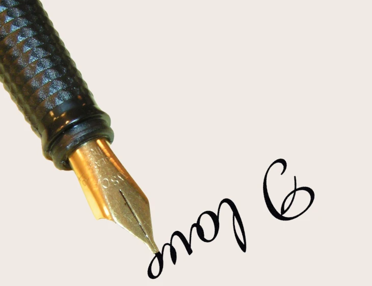 a pencil with a fountain pen pointing down at soing