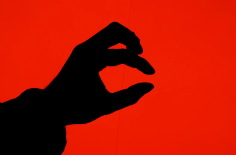 a hand is pointed to the red background