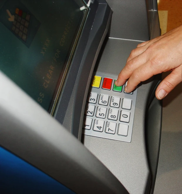 a person using a computer kiosk to pay