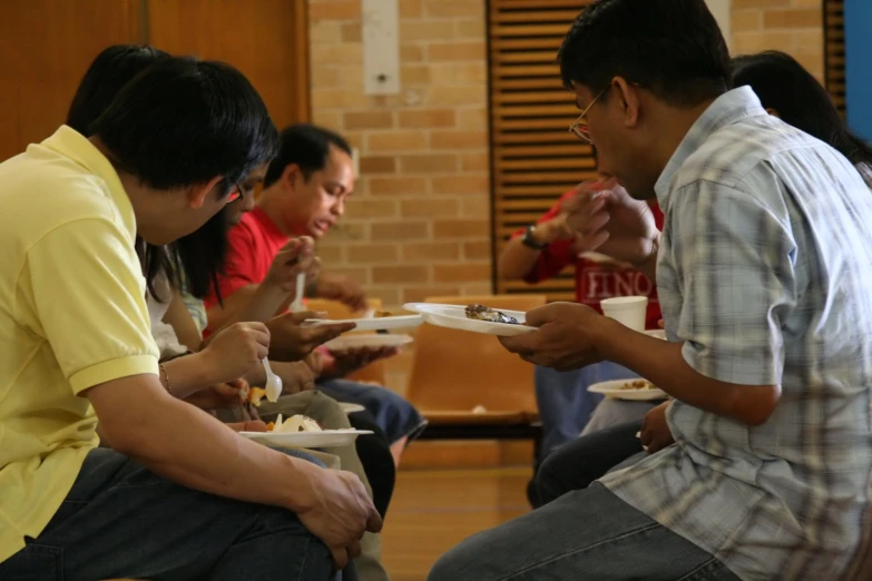 some people sitting around eating in a room