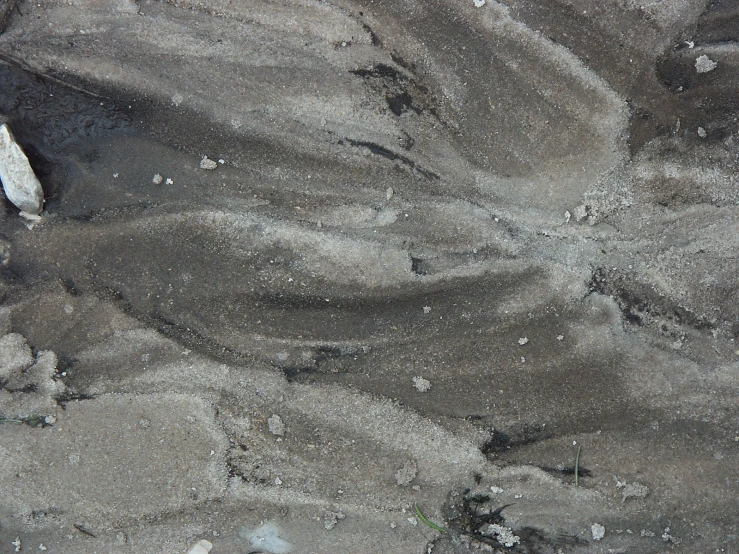 an aerial view shows rocks, water and grass