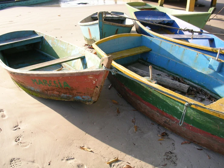 small boat in the sand on the beach