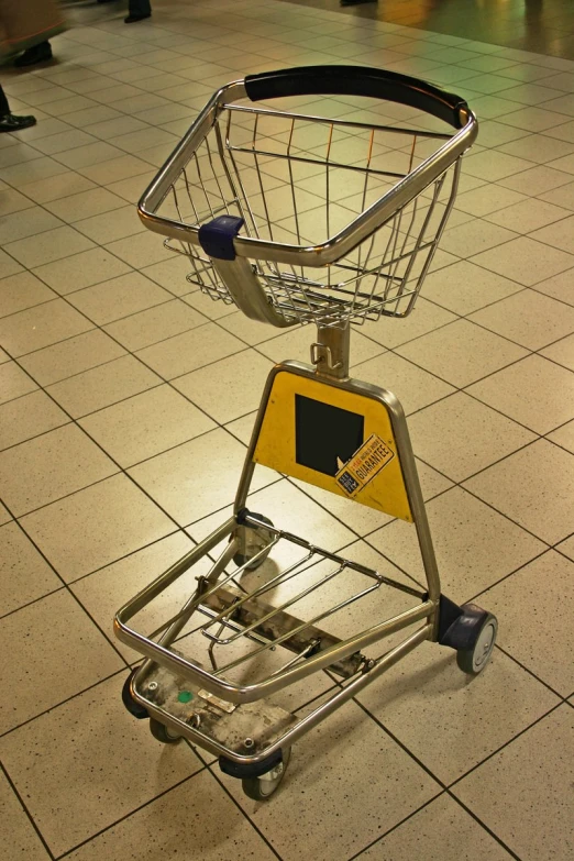 a shopping cart in an airport with the seat attached to it