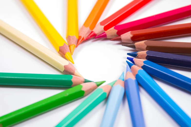 a round circle of colored pencils with a yellow tip