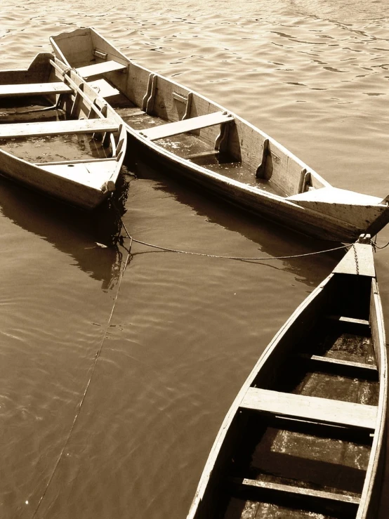 two small boats sitting on top of a lake