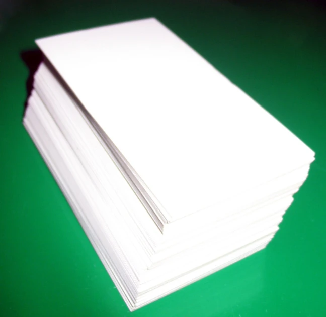 a stack of white folded napkins sitting on top of a table