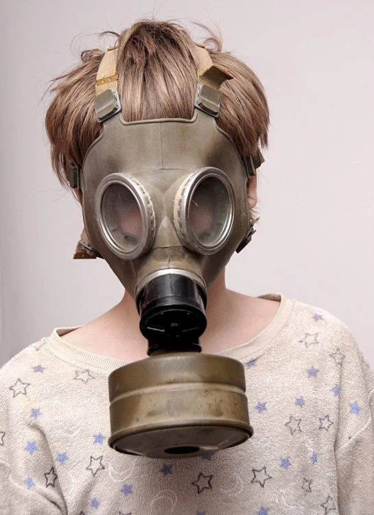 the girl wears an old gas mask