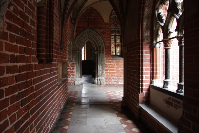 arched arches and floors line a stone hall