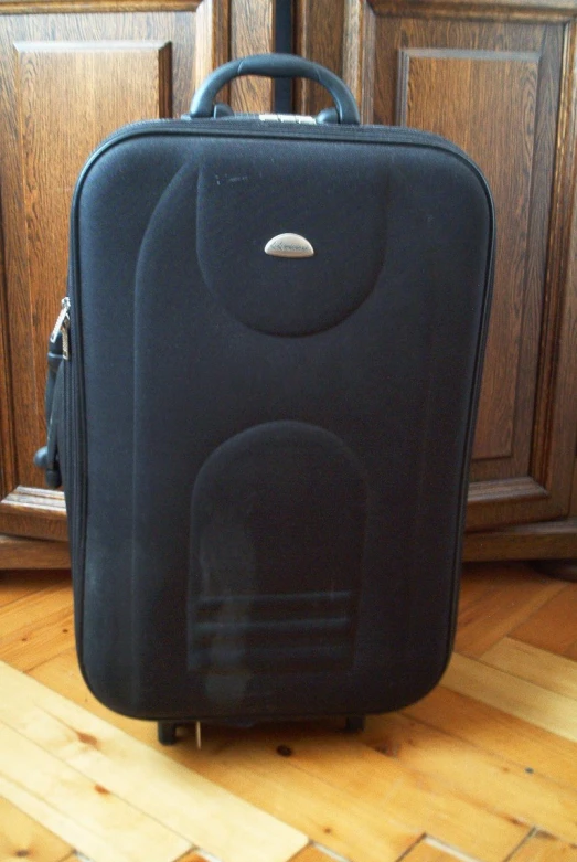 an empty piece of luggage sitting on the floor