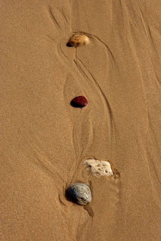 two rocks on a sand dune with ripples