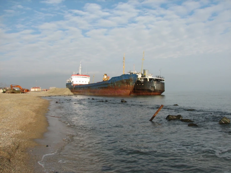 an old boat that is sitting on the shore