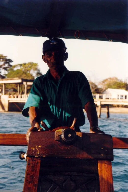 a man sitting on top of a wooden boat